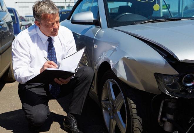 green car with insurance documents on dashboard